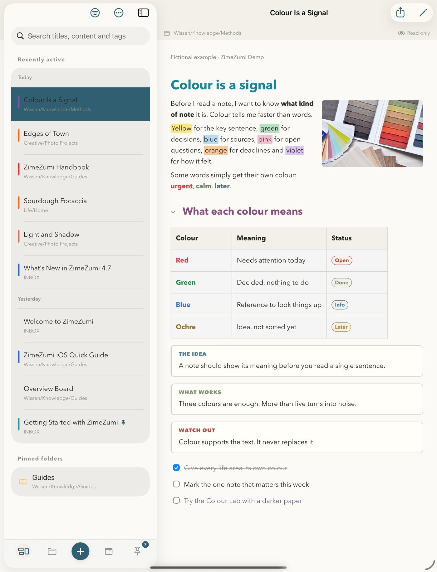 ZimeZumi on iPad: the recently active list on the left, the note Colour Is a Signal on the right with a photo beside the text, a table with badges and knowledge blocks.